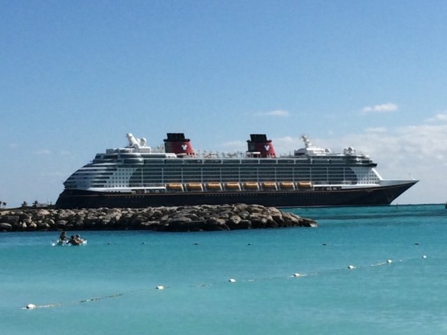 the Disney Dream docked at Disney Cruise Line's private island, Castaway Cay