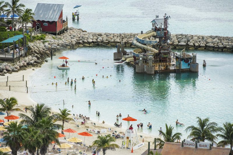 Guests slide and splash on Pelican Plunge, an exciting water play area located within swimming distance from the shore at Castaway Cay. The 2,400-square-foot floating platform has two water slides—an enclosed corkscrew slide and a 140-foot-long open slide—that take guests on a twisting ride, ending with a splash into the lagoon. A giant "bucket dump" and water cannons soak guests on the platform.