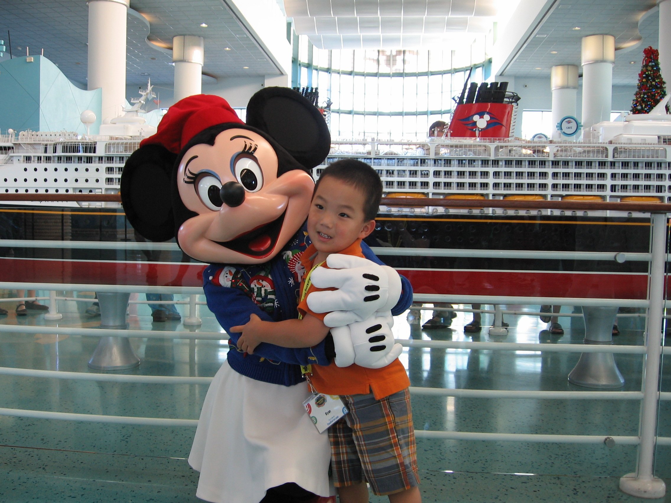 Minnie Mouse greets guests waiting to board the Disney Cruise ships